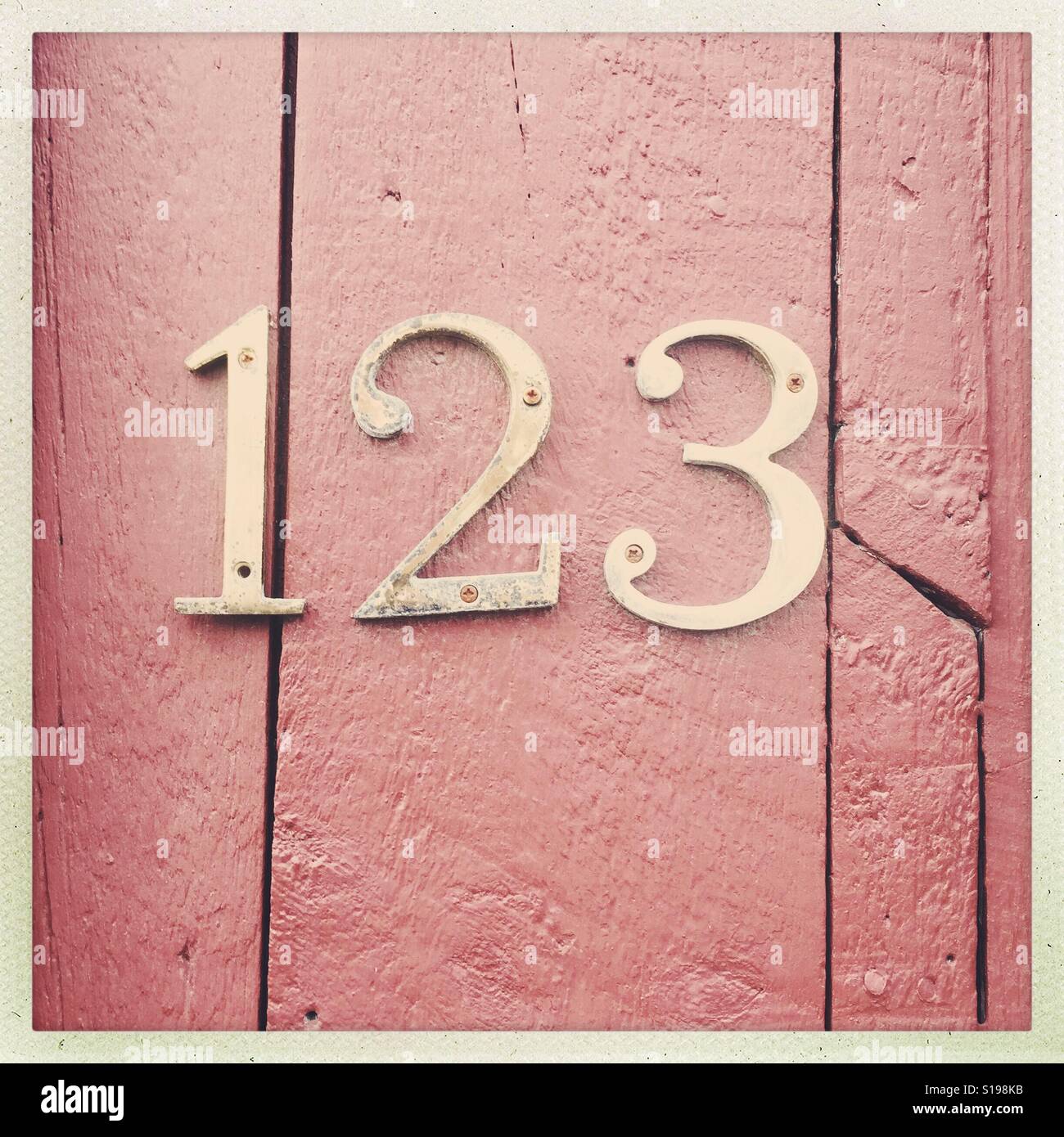 Numbers - 123 - on a red wooden wall. Stock Photo