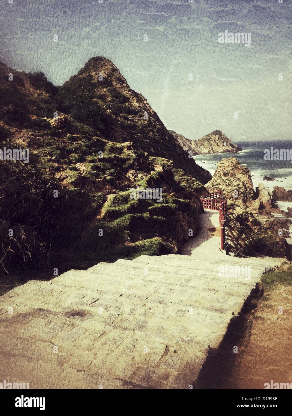 The way down to rocky beach. - Smartphone Captured Stock Image