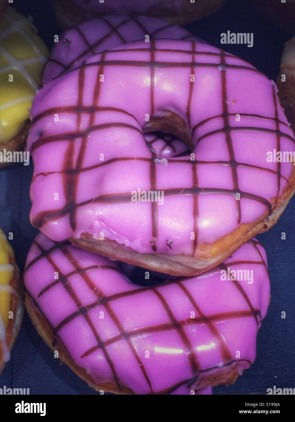 Lilac glazed doughnut lined  with chocolate detail Stock Photo