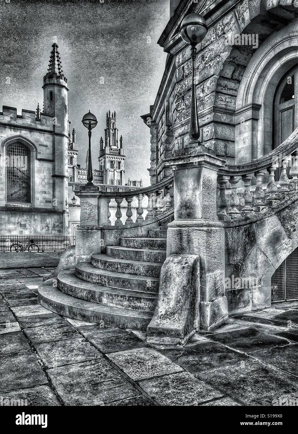 A high contrast monochrome photograph of the steps leading up to the north entrance of the Radcliffe Camera Building in Oxford, England. Behind, is All Souls College. Photo Credit - © COLIN HOSKINS. - Smartphone Captured Stock Image