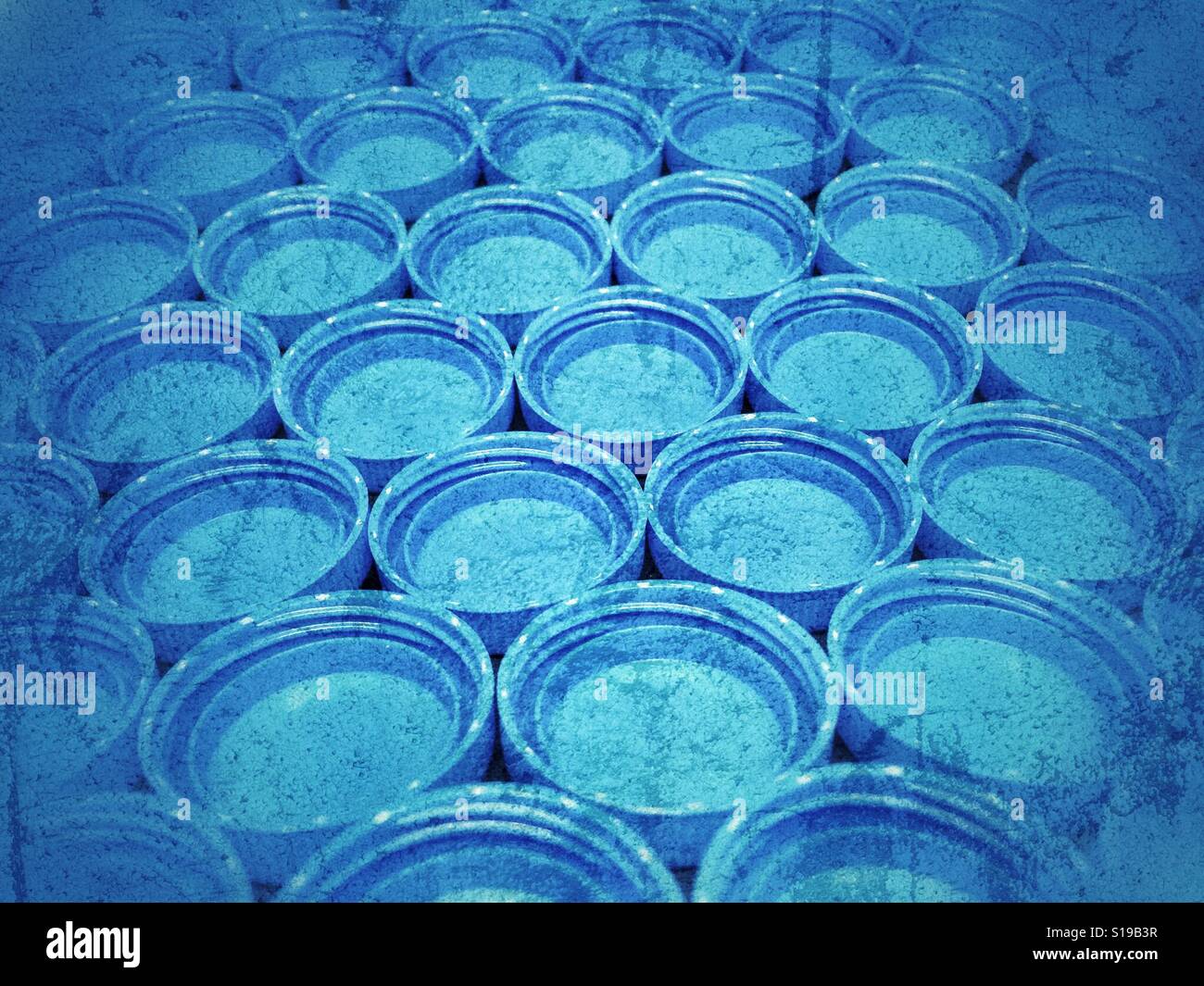 Blue plastic bottle caps in grunge Stock Photo