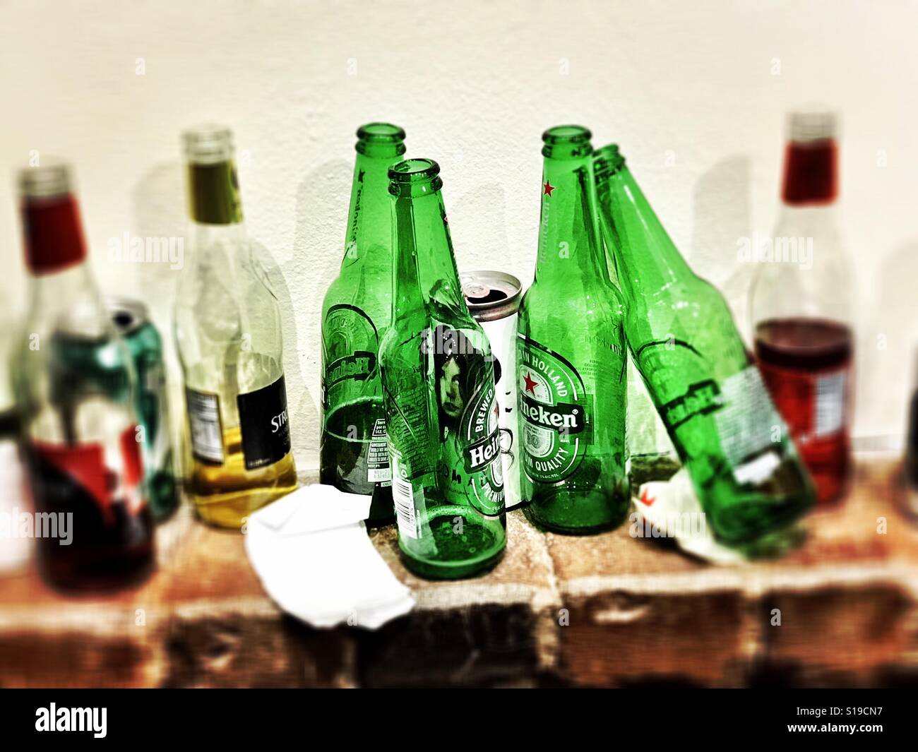 A row of empty and half full beer bottles. Stock Photo