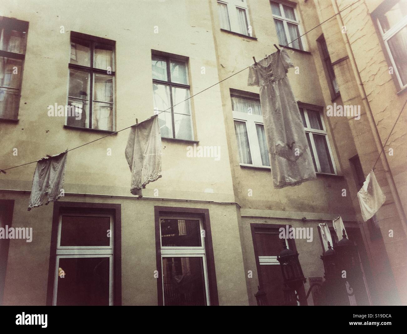 Vintage clothes hanging out to get dried in front of a building, old laundry Stock Photo