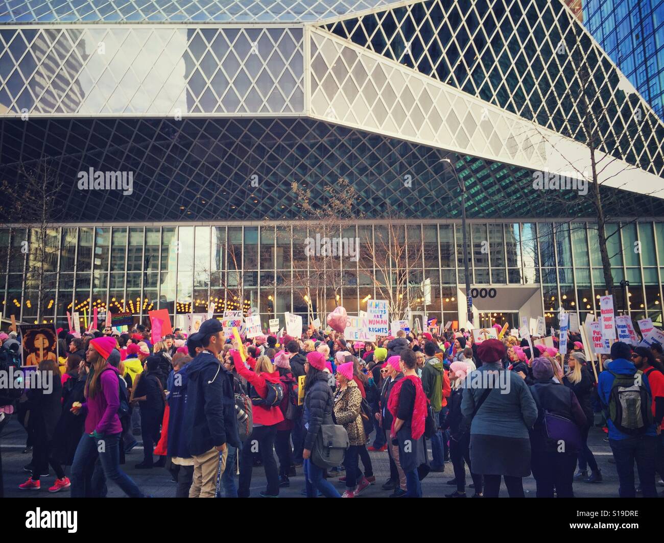 Protesters walk by Seattle Public Library during Women's March on January 21st 2017 - Smartphone Captured Stock Image