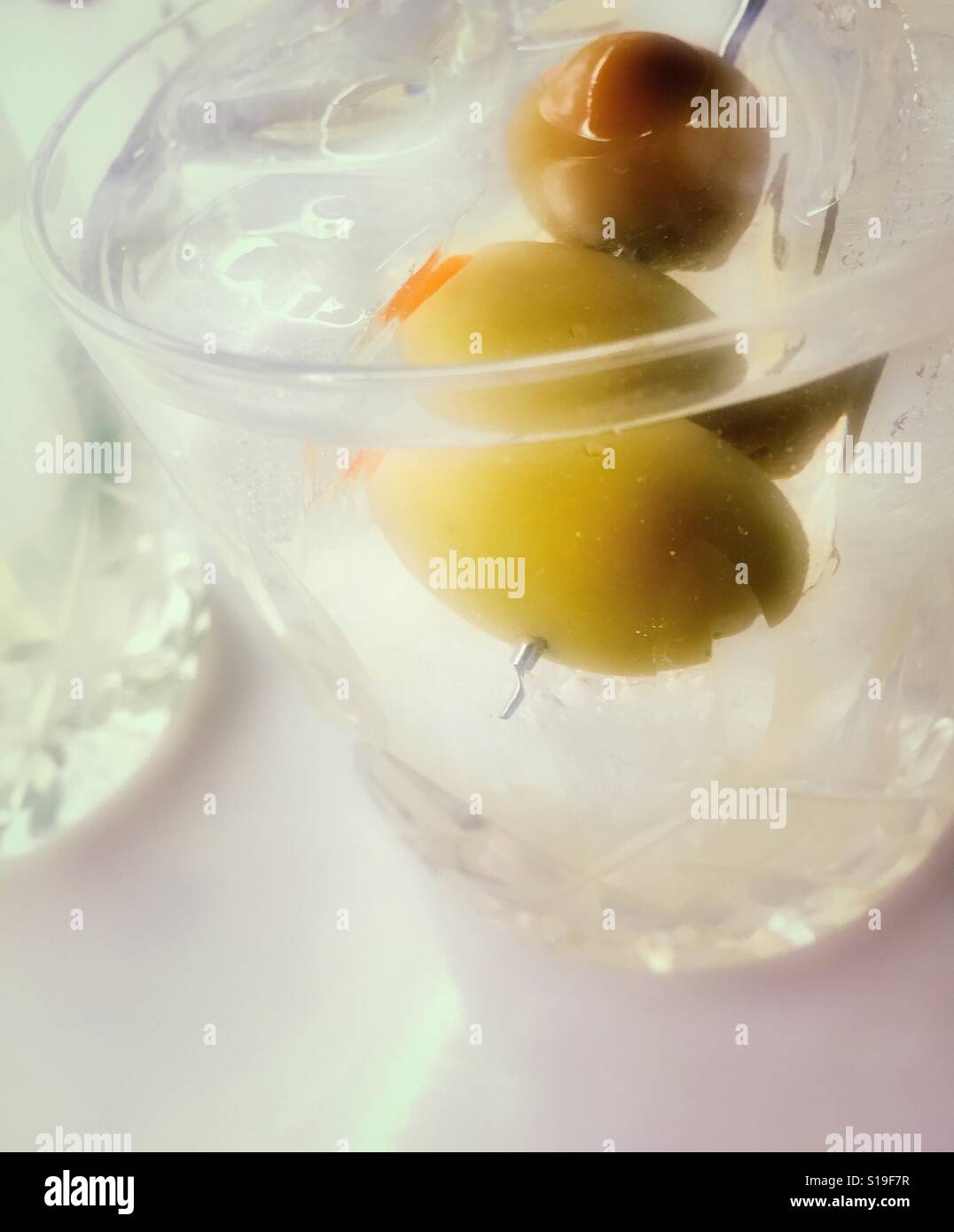 Martini cocktail on ice in crystal glass with olives - Smartphone Captured Stock Image