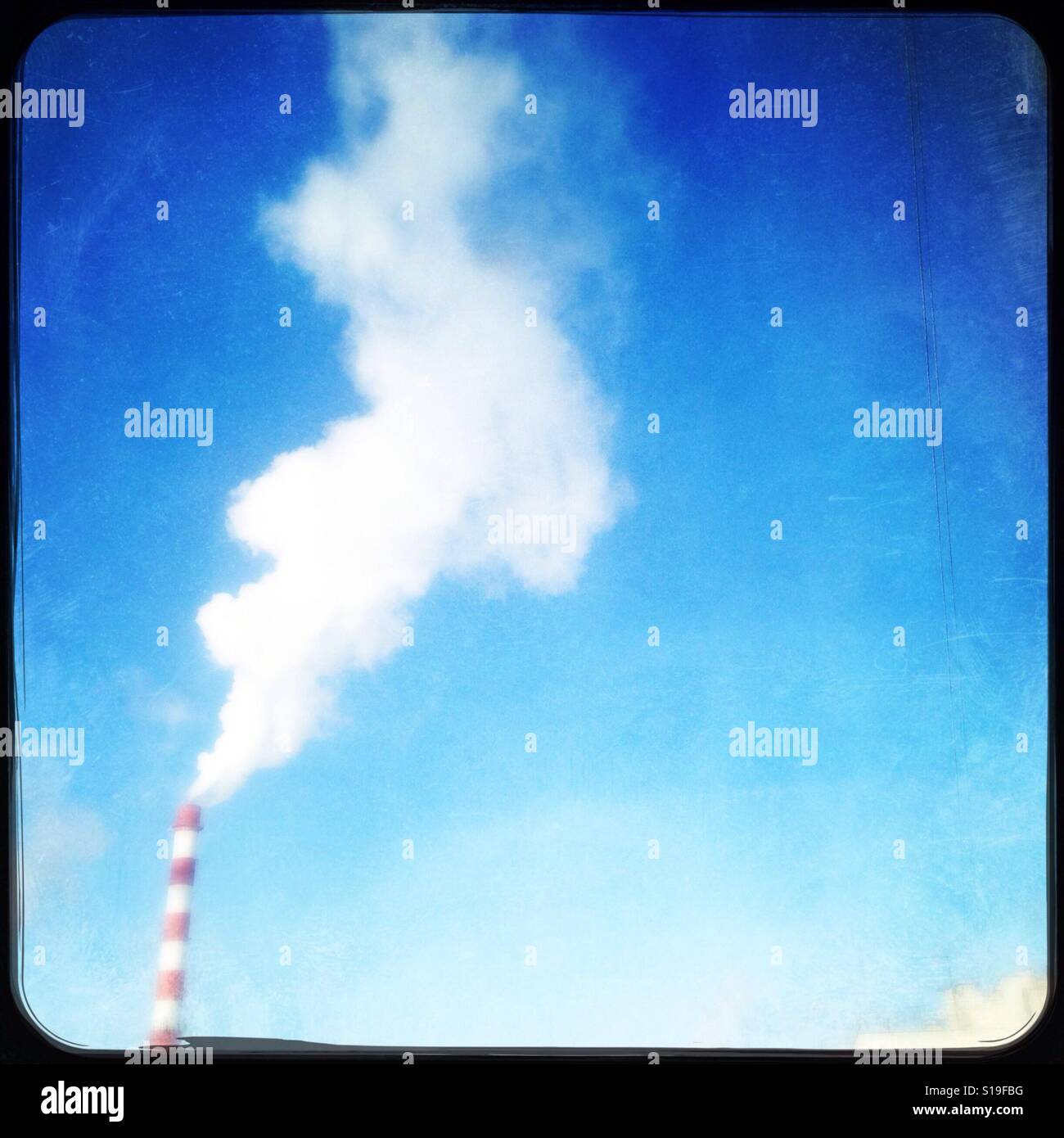 Smoke stack, view from window, contrast with blue sky Stock Photo - Alamy