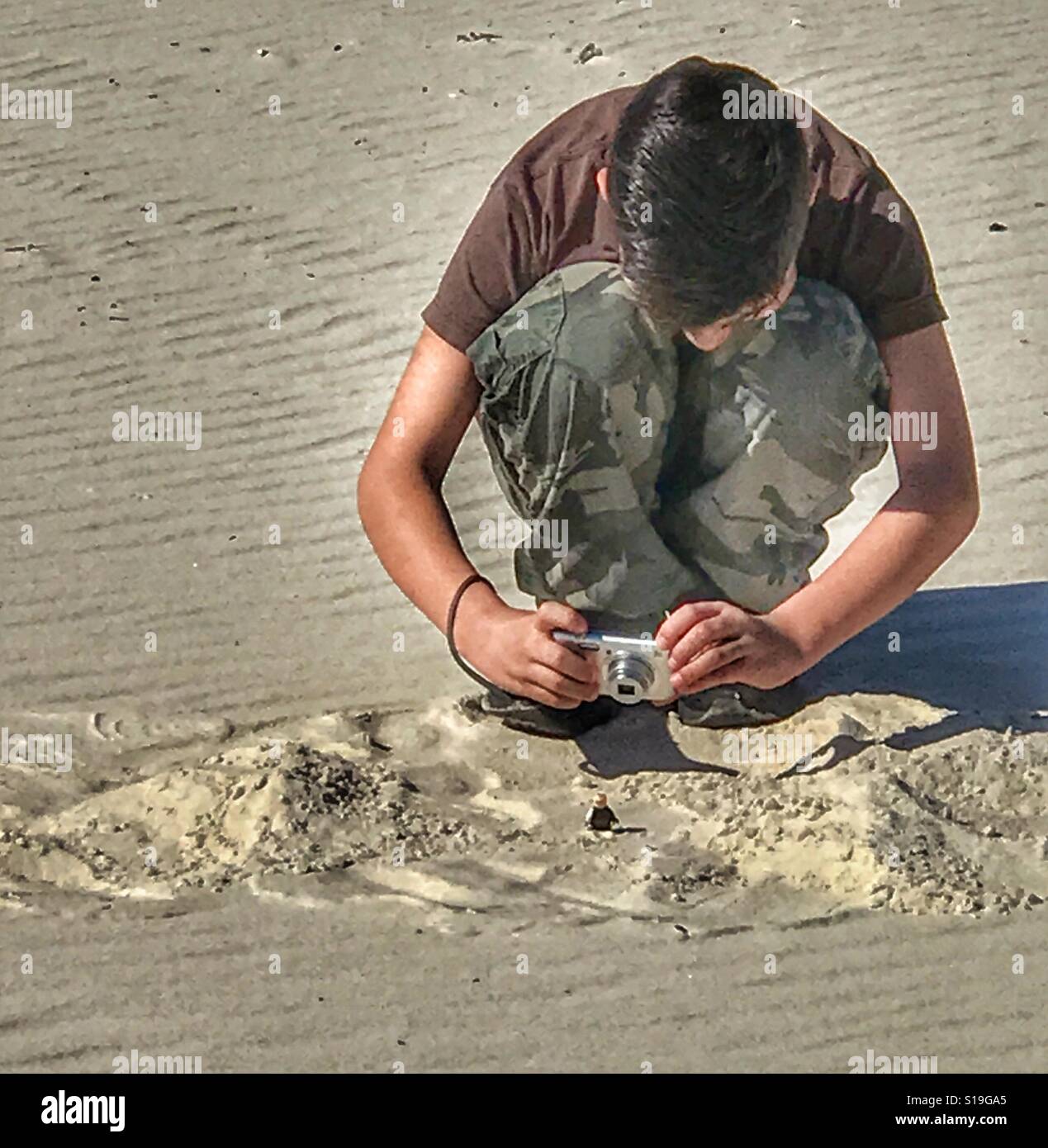 Young man staging photos on Gulfport beach Stock Photo