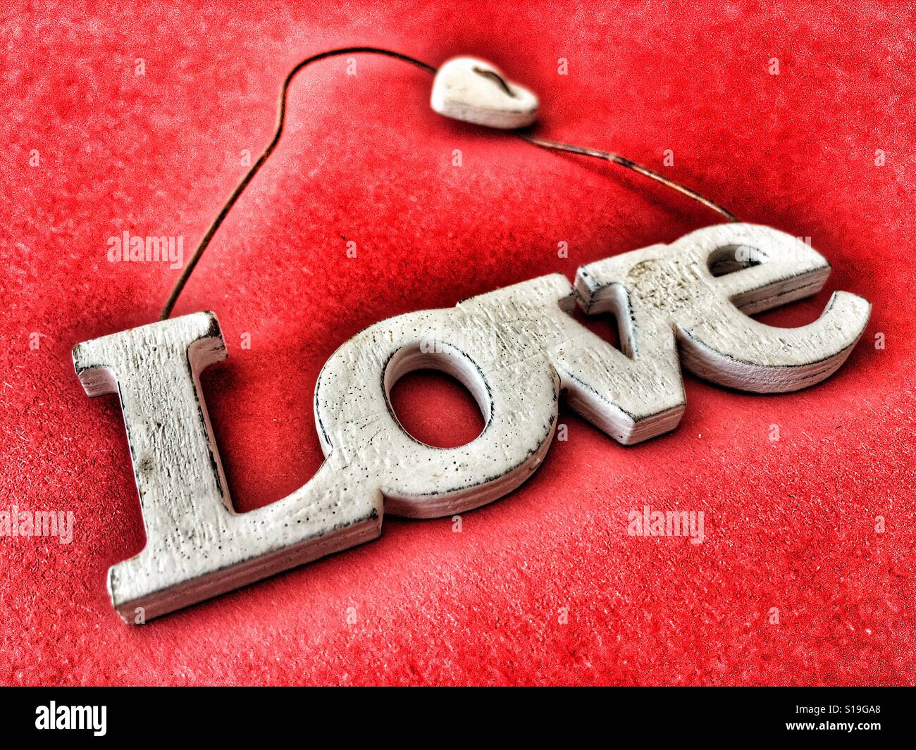 Love, word carved in wood as hanging decoration - Smartphone Captured Stock Image