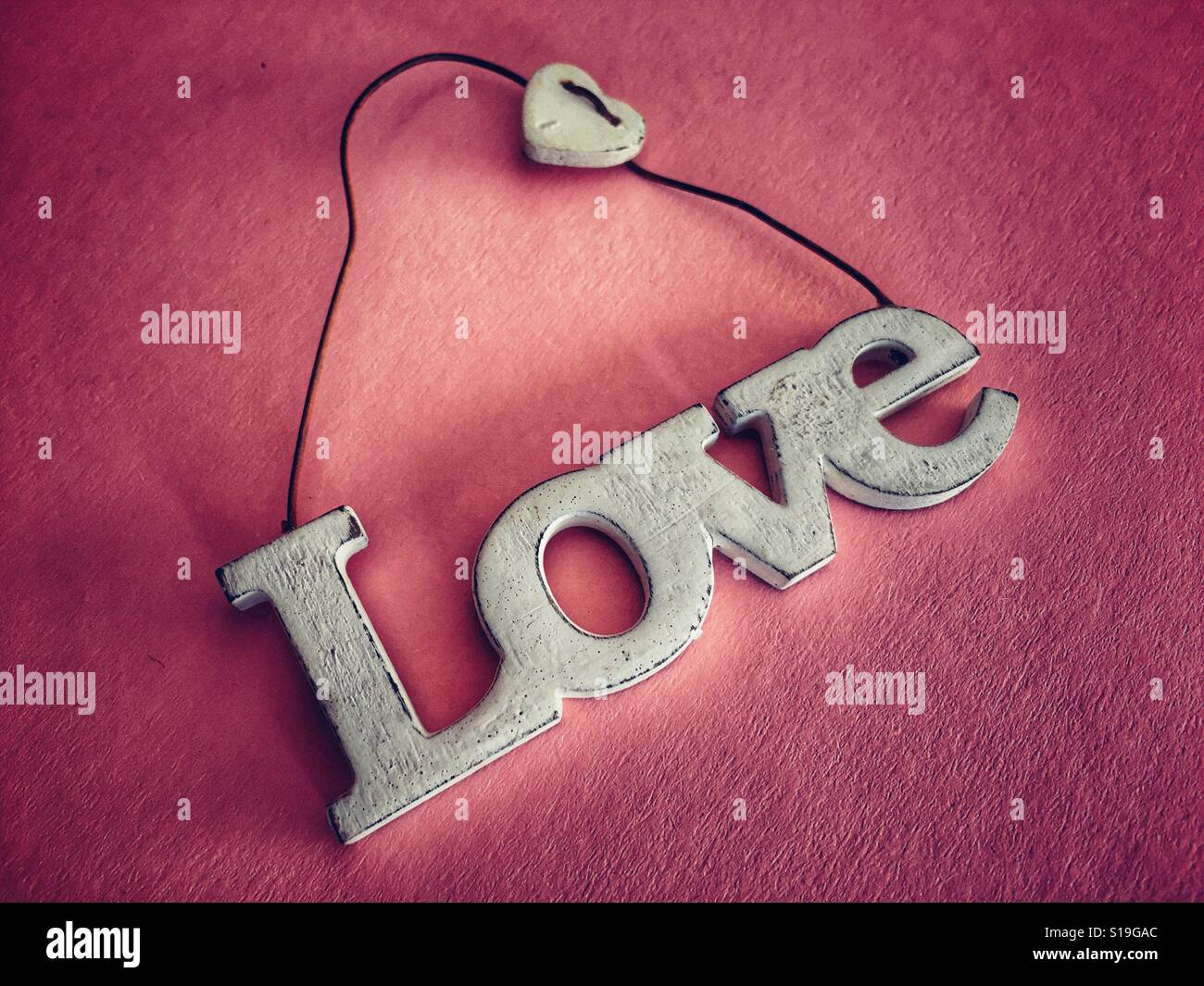 Love, word carved in wood as hanging decoration - Smartphone Captured Stock Image