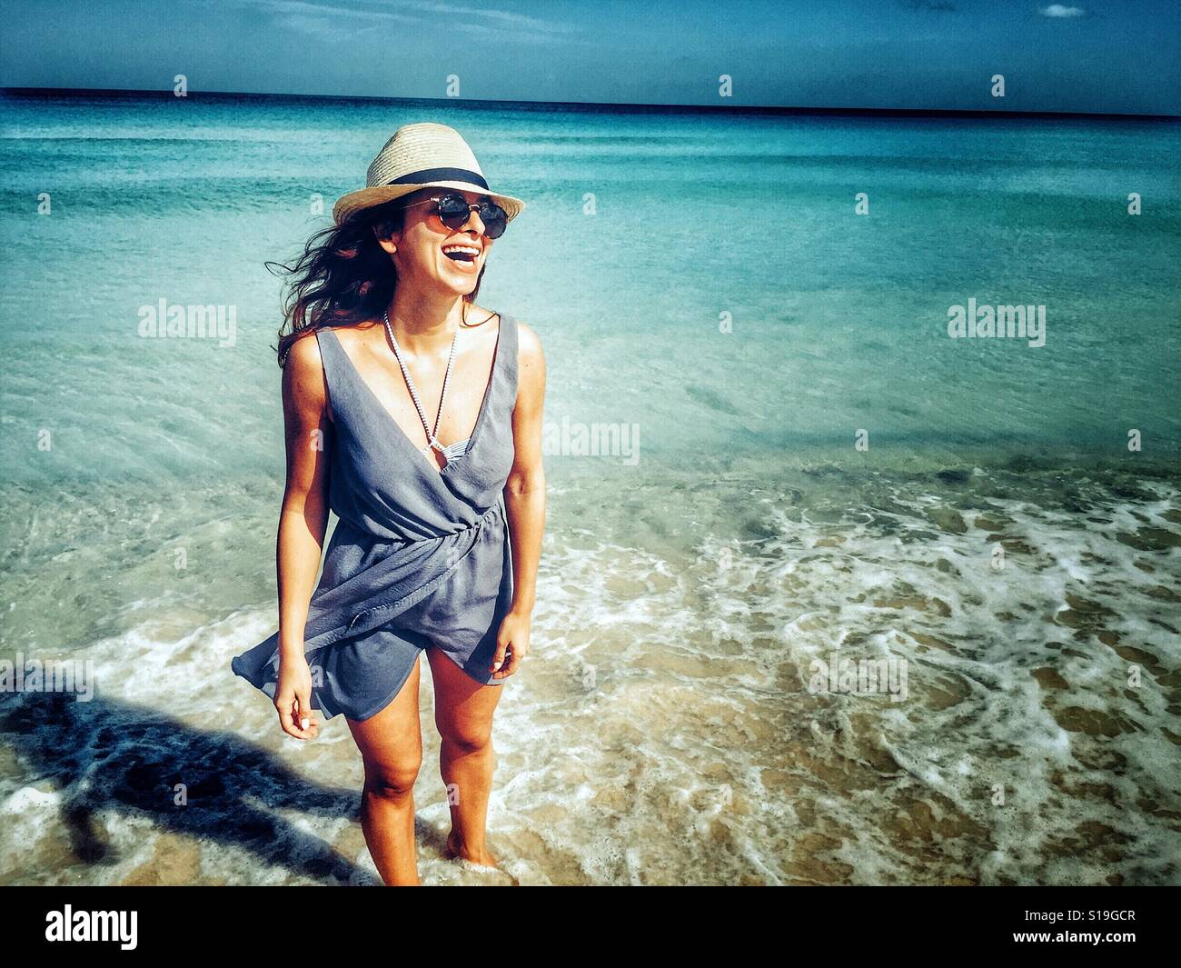 Smiling young woman at the beach Stock Photo - Alamy