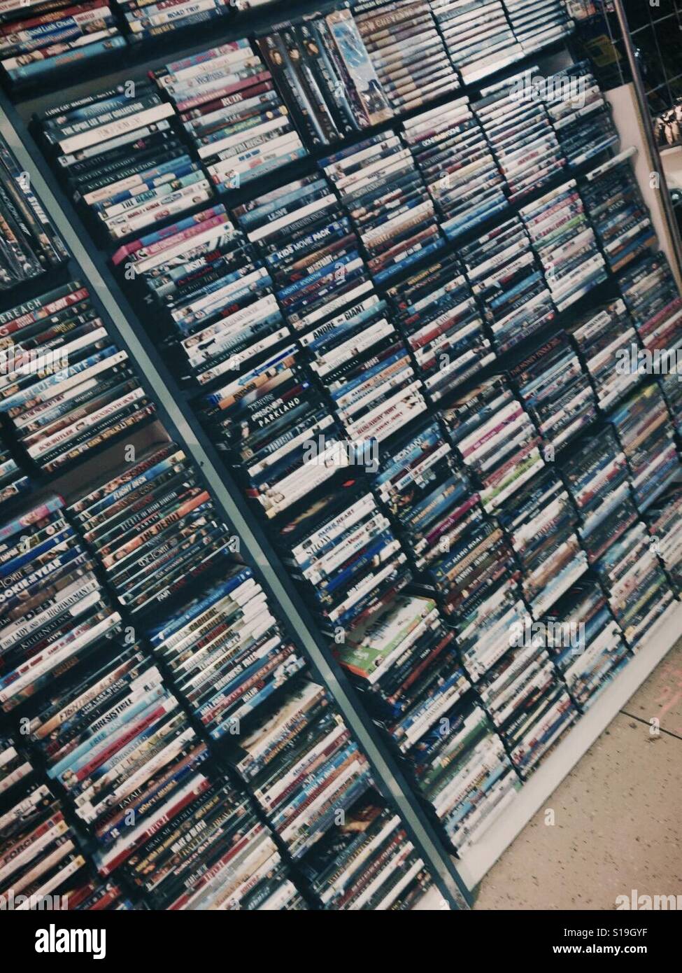 Stacks of Movie DVDs on Shelves Stock Photo