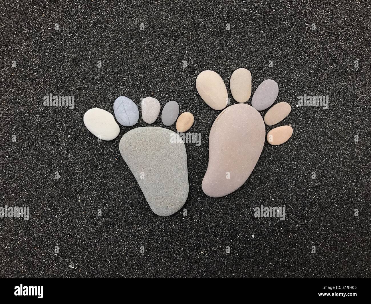 Stone feets over black volcanic sand - Smartphone Captured Stock Image