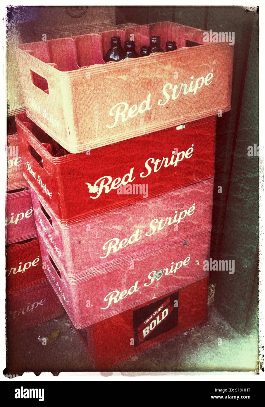 Stacked crates of empty Red Stripe beer bottles Stock Photo