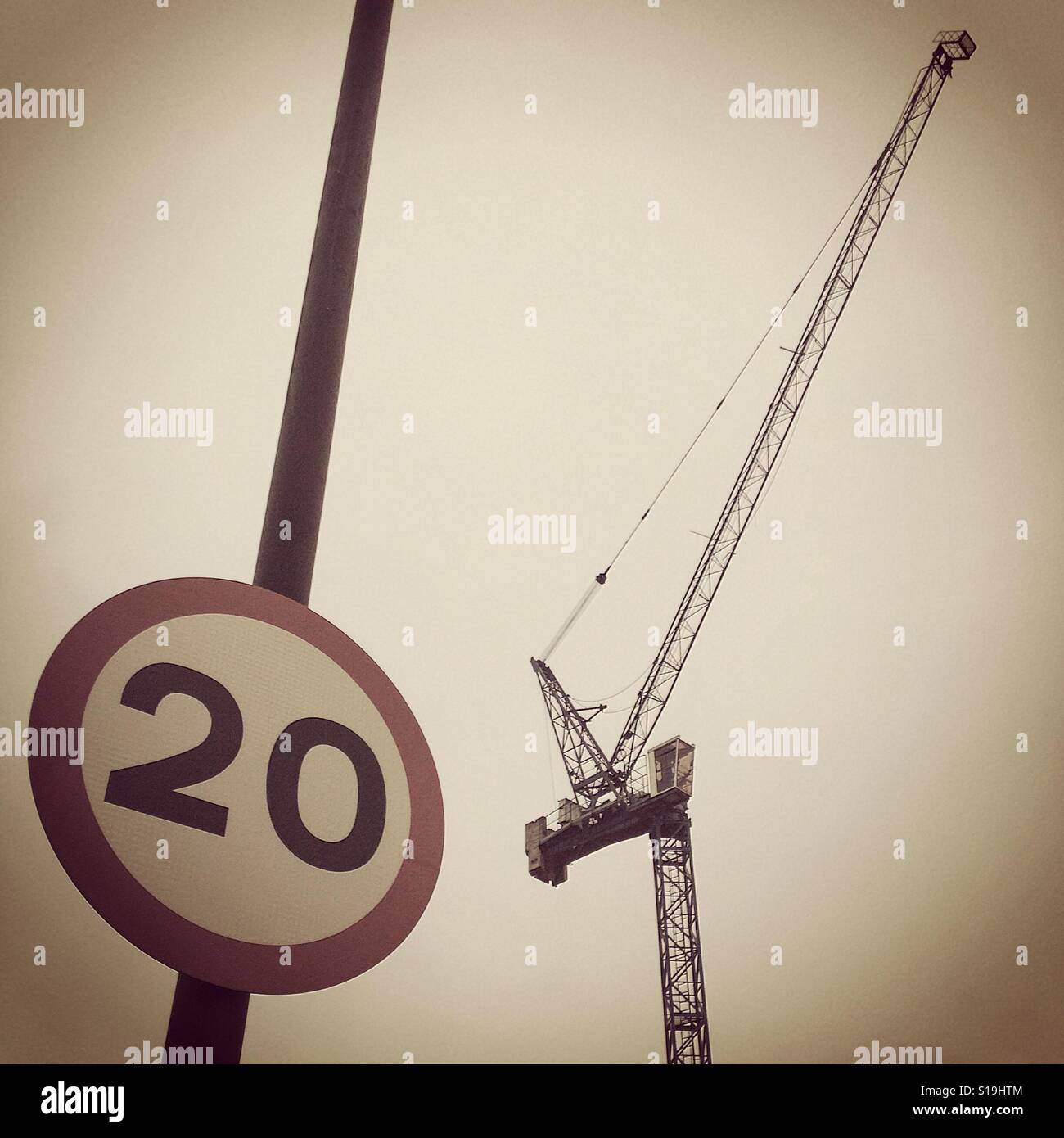 Crane with a speed restriction sign Stock Photo