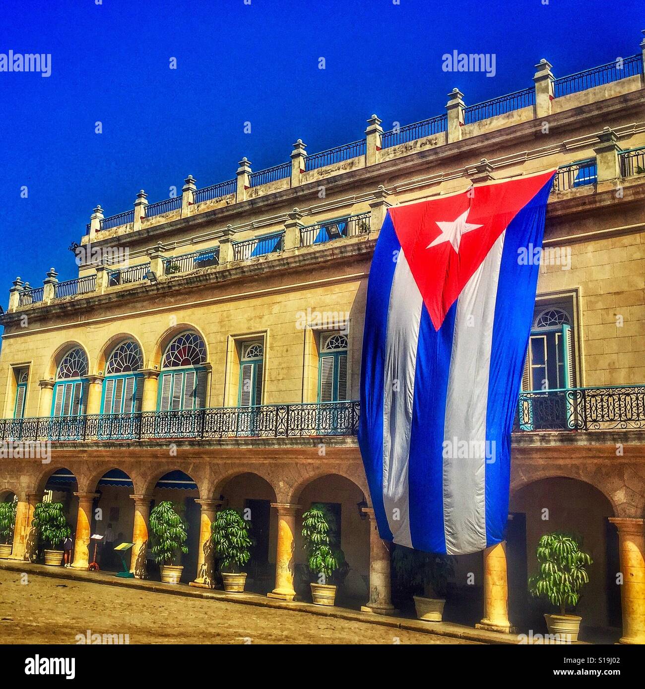 Building with a hung Cuban flag in Havana Stock Photo