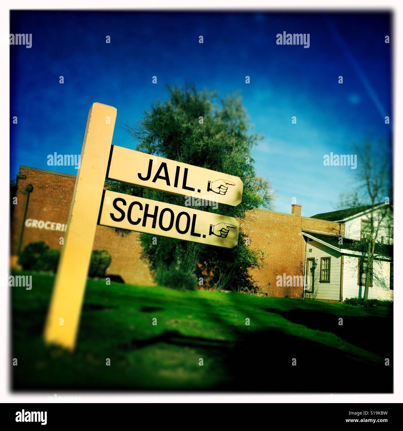 Jail and school sign on Main Street. Columbia State Historic Park, Columbia, Tuolumne County,  California, USA - Smartphone Captured Stock Image