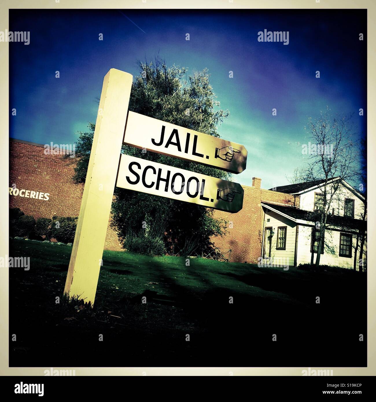 Jail and school sign on Main Street. Columbia State Historic Park, Columbia, Tuolumne County,  California, USA - Smartphone Captured Stock Image
