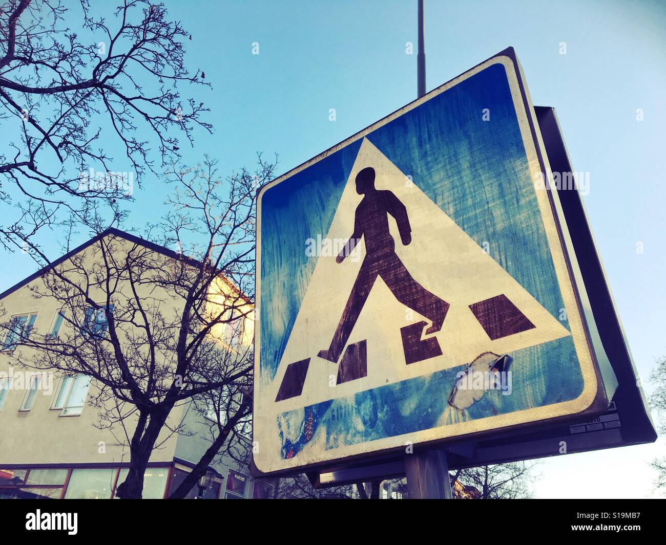 Weathered pedestrian crossing sign in Stockholm, Sweden - Smartphone Captured Stock Image