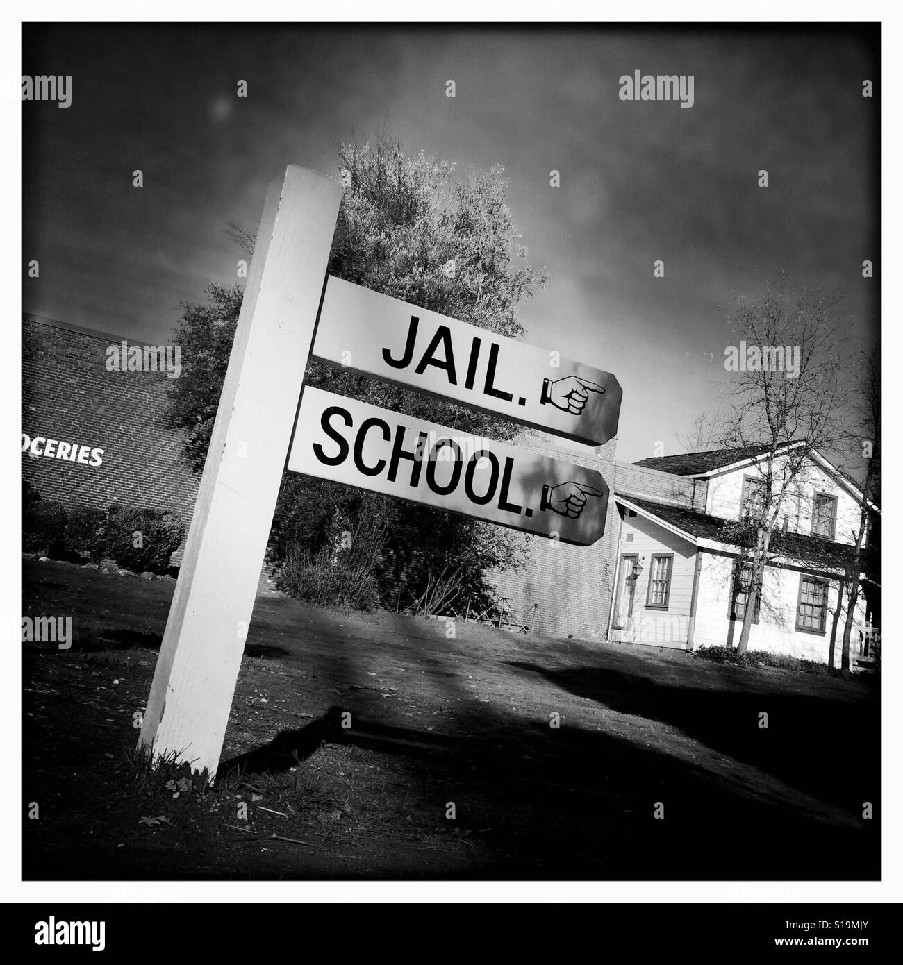 Jail and school sign on Main Street. Columbia State Historic Park, Columbia, Tuolumne County,  California, USA Stock Photo