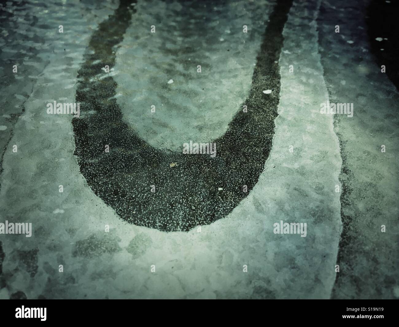 U form shape from air bubble in ice - Smartphone Captured Stock Image
