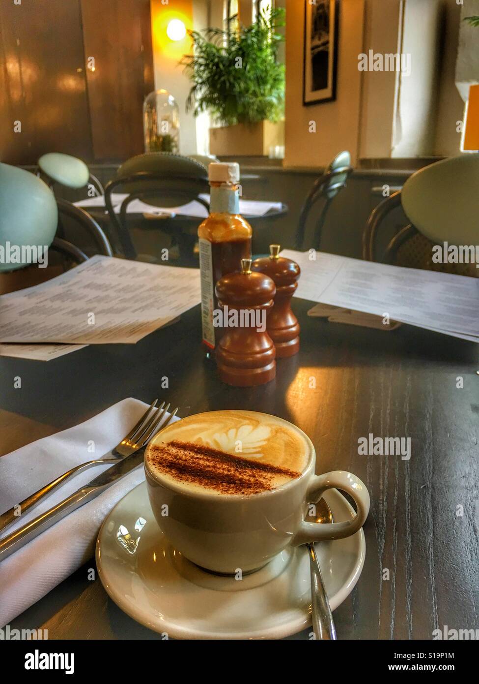 Cappuccino coffee on the table in a restaurant - Smartphone Captured Stock Image
