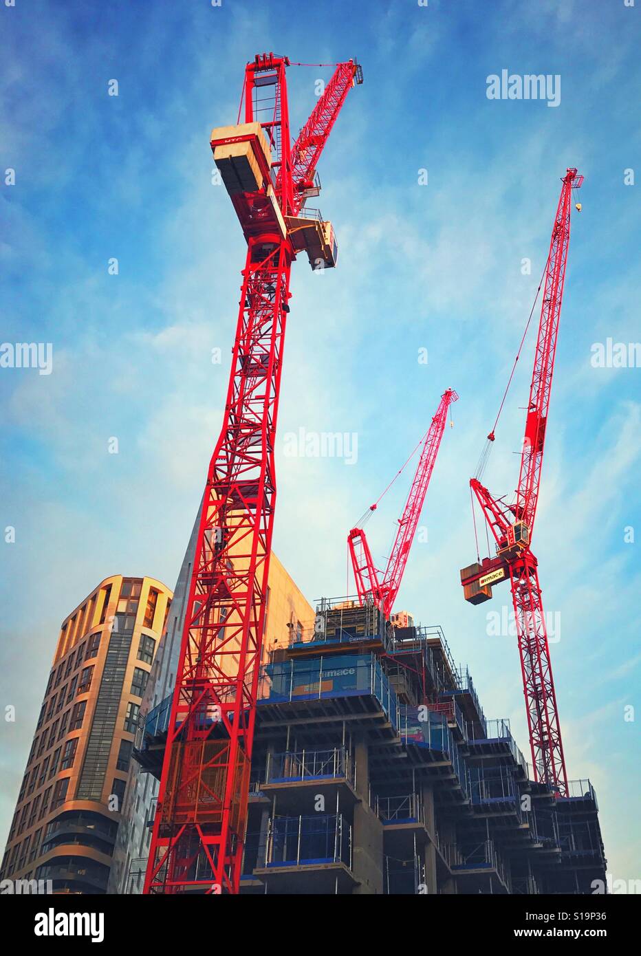 Red construction cranes on a site in London - Smartphone Captured Stock Image