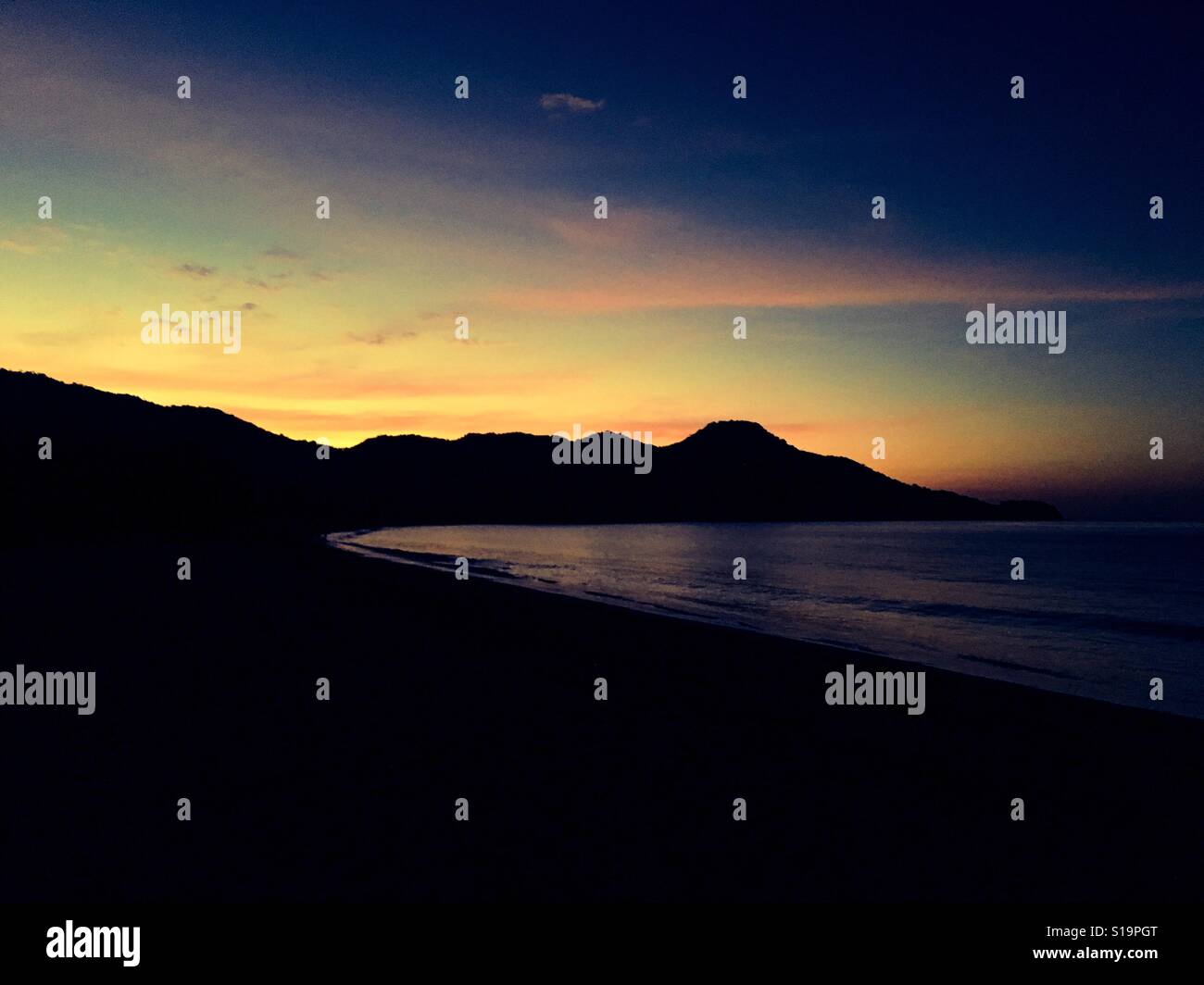 Tropical sunset over coastal headland - Smartphone Captured Stock Image