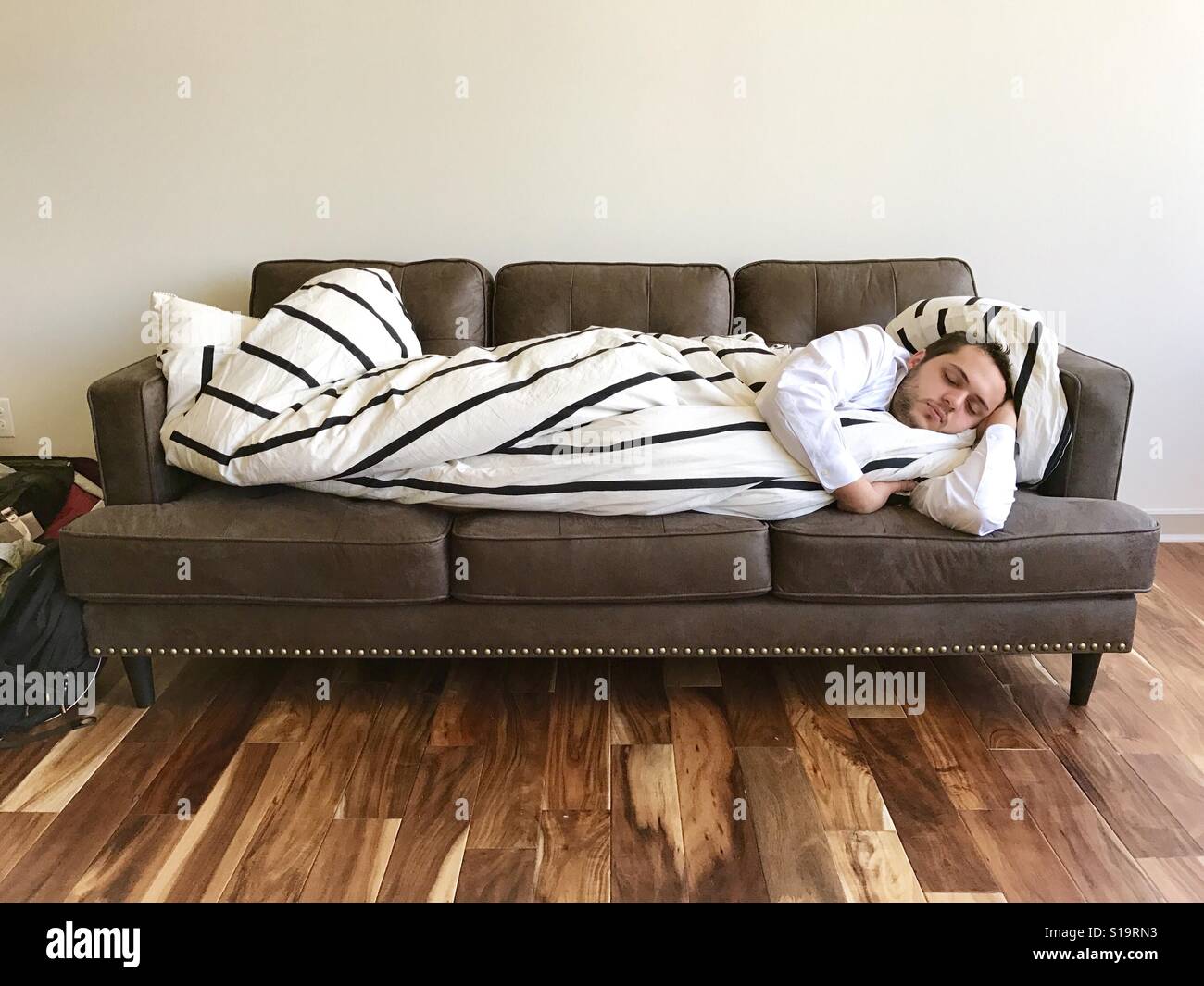 Sleeping on a couch in style Stock Photo Alamy