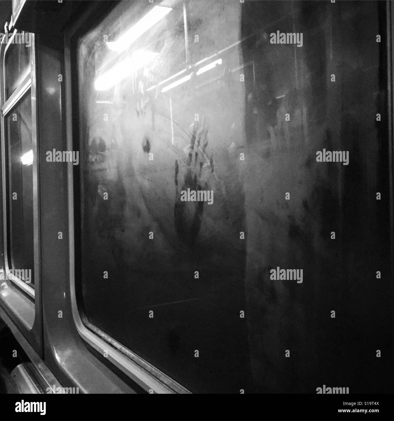 A hand print on the fogged up window of the subway. Stock Photo