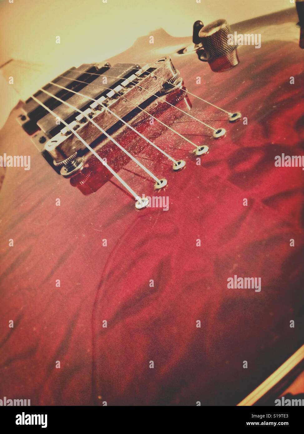 Guitar bridge, pins, saddle and strings Stock Photo