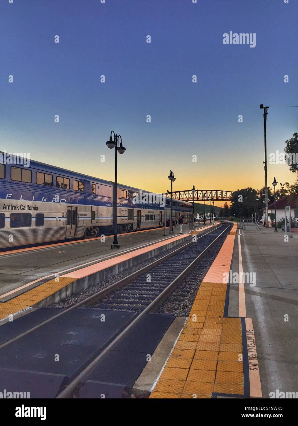 Train pulling away from train station in early morning from the Amtrak train station in San Luis Obispo, California Stock Photo