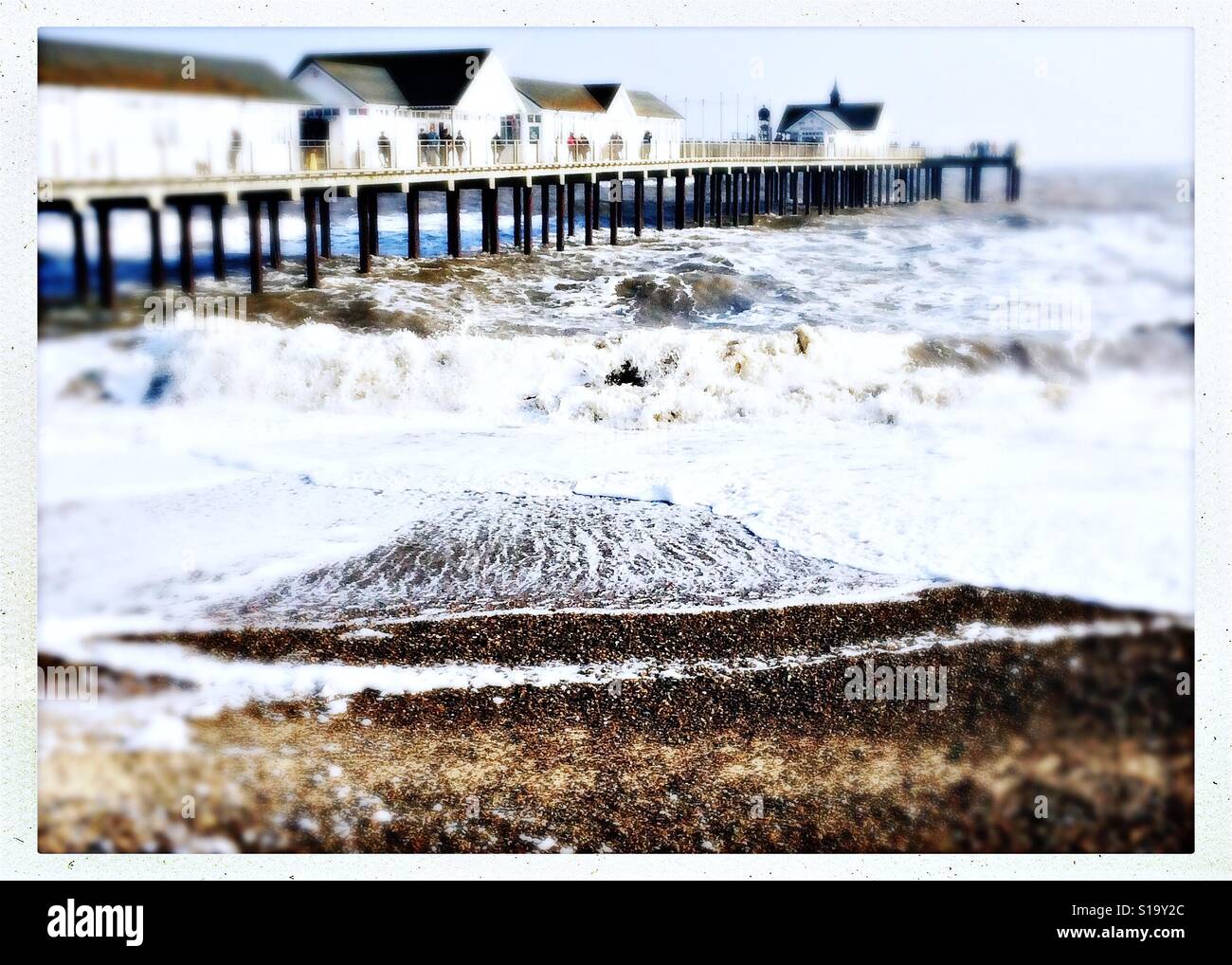 Seaside in winter. Rough sea around Southwold pier on a cold February day. Stock Photo