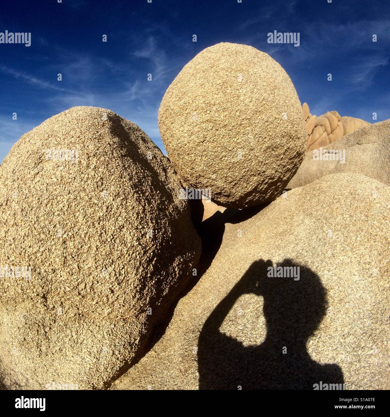 Photographing granite boulders with smartphone, Joshua Tree National Park, California - Smartphone Captured Stock Image