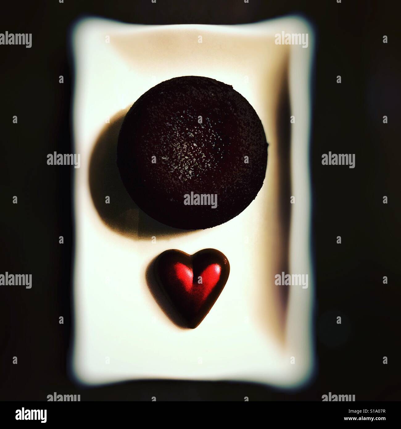 Chocolate fondant and a heart shaped chocolate - Smartphone Captured Stock Image