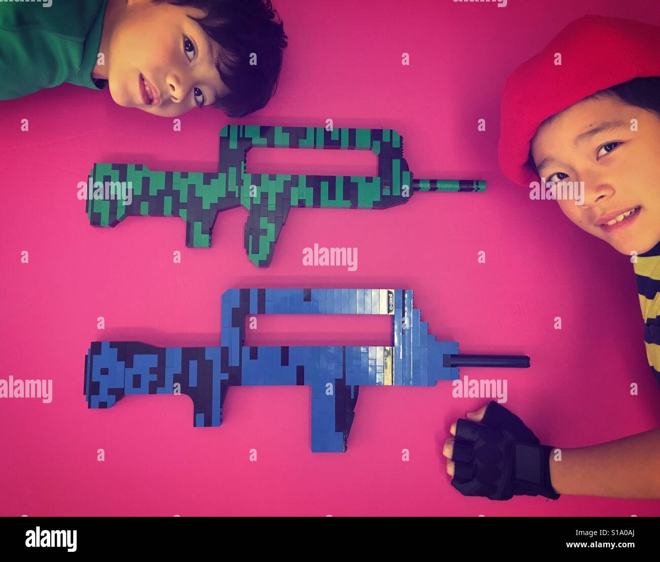 Machine guns toys on pink carpet Stock Photo