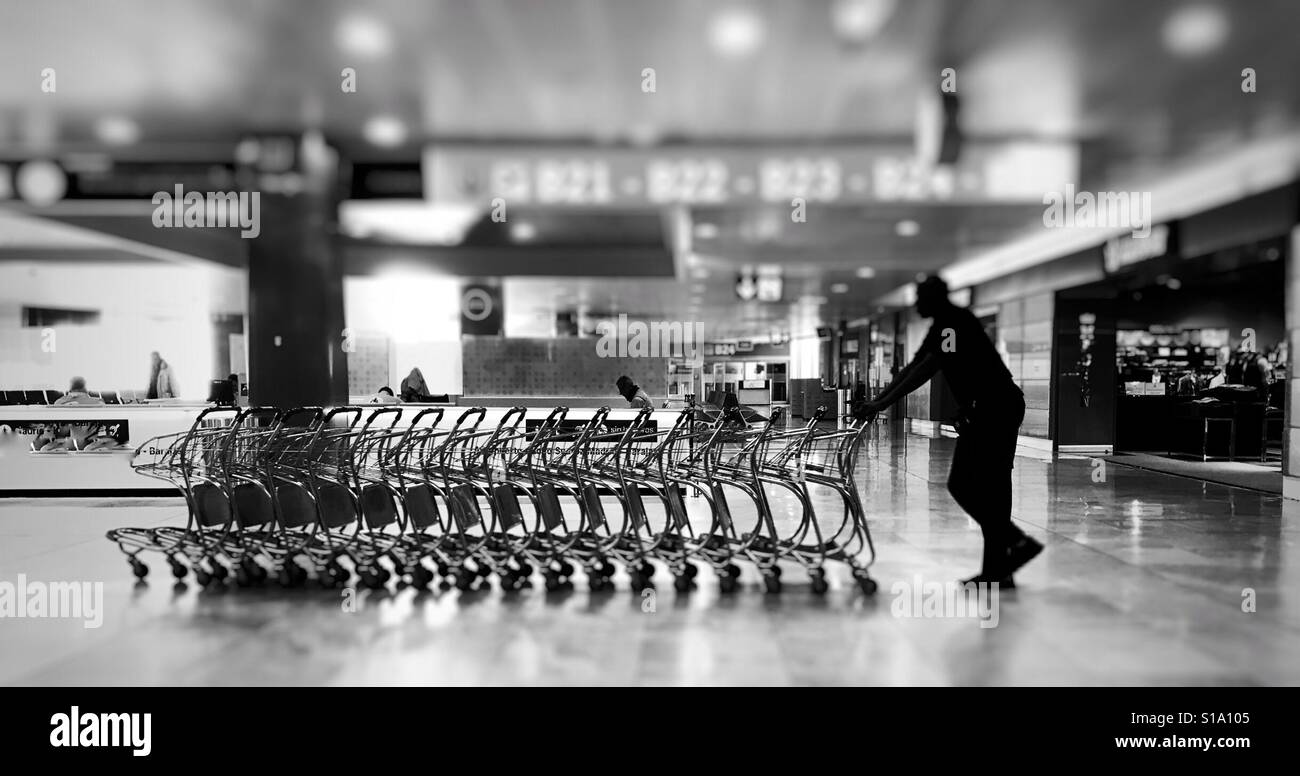 Airport trolley man Stock Photo