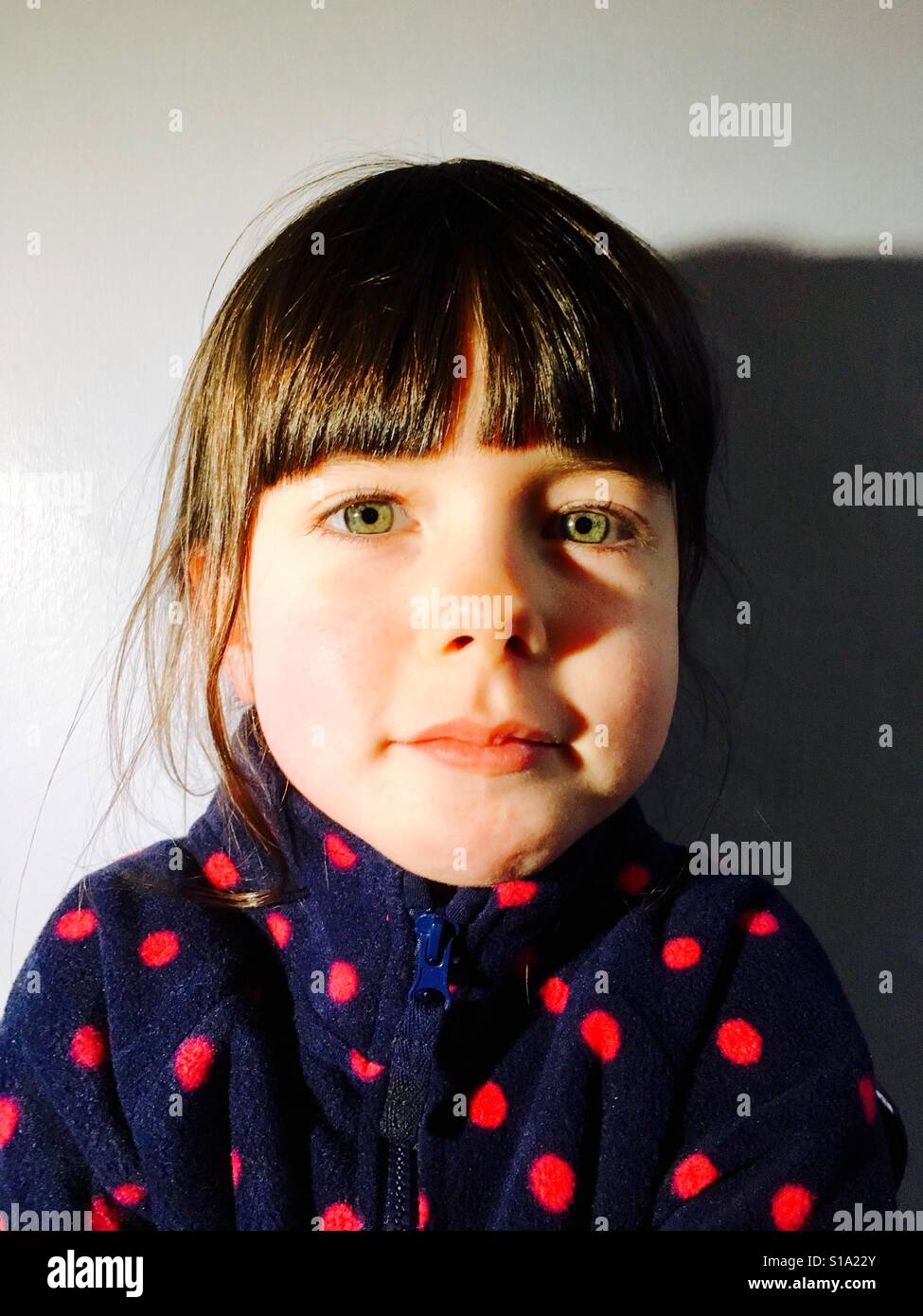 5-year old girl wearing red poker-dot fleece - Smartphone Captured Stock Image