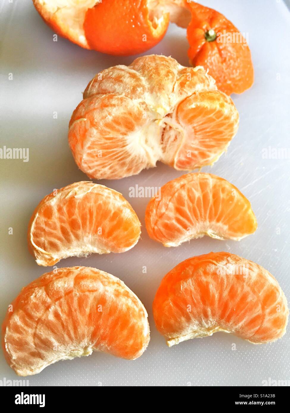 Mandarin orange segments with the peel in the background - Smartphone Captured Stock Image