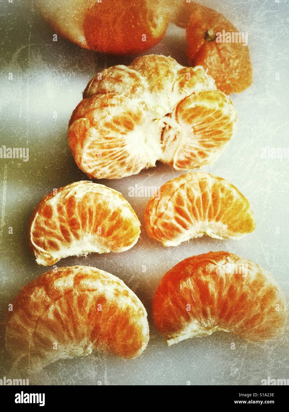 Mandarin orange segments with the peel in the background - Smartphone Captured Stock Image