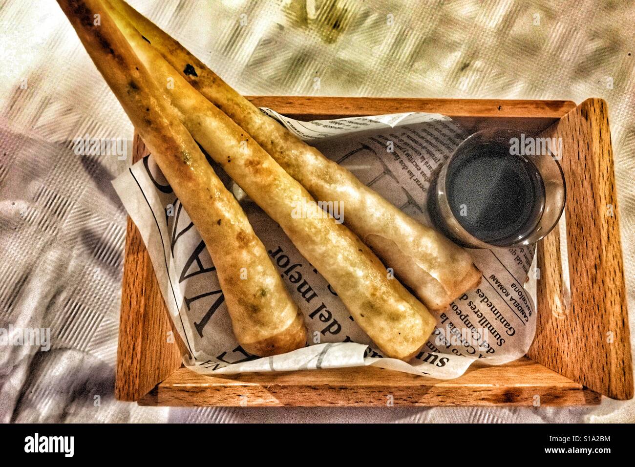 Langoustine parcels with hot sauce, in a Spanish tapas bar. - Smartphone Captured Stock Image