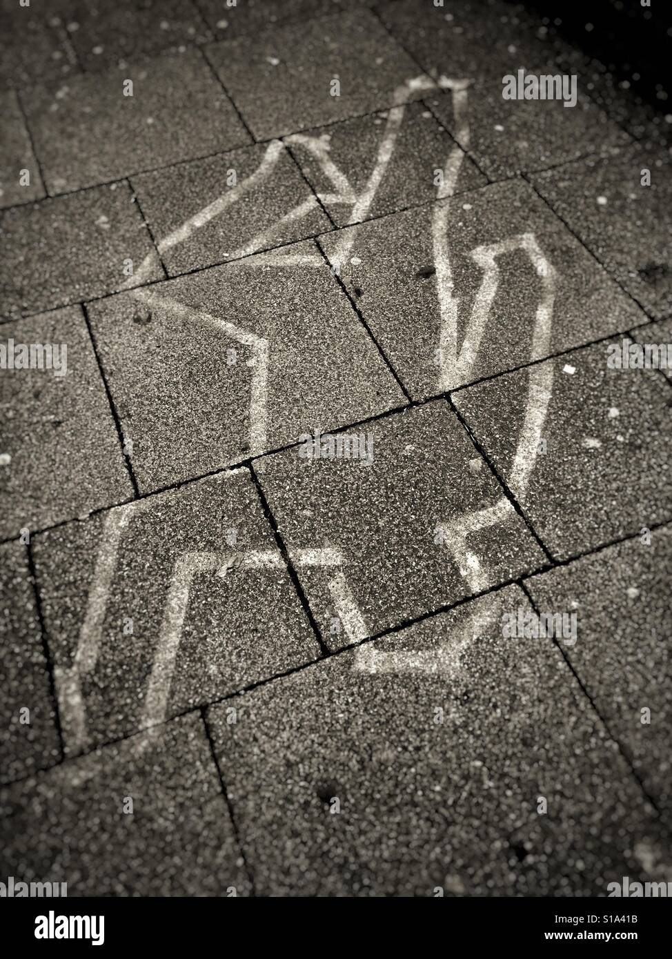 Chalk outline of body on the pavement Stock Photo