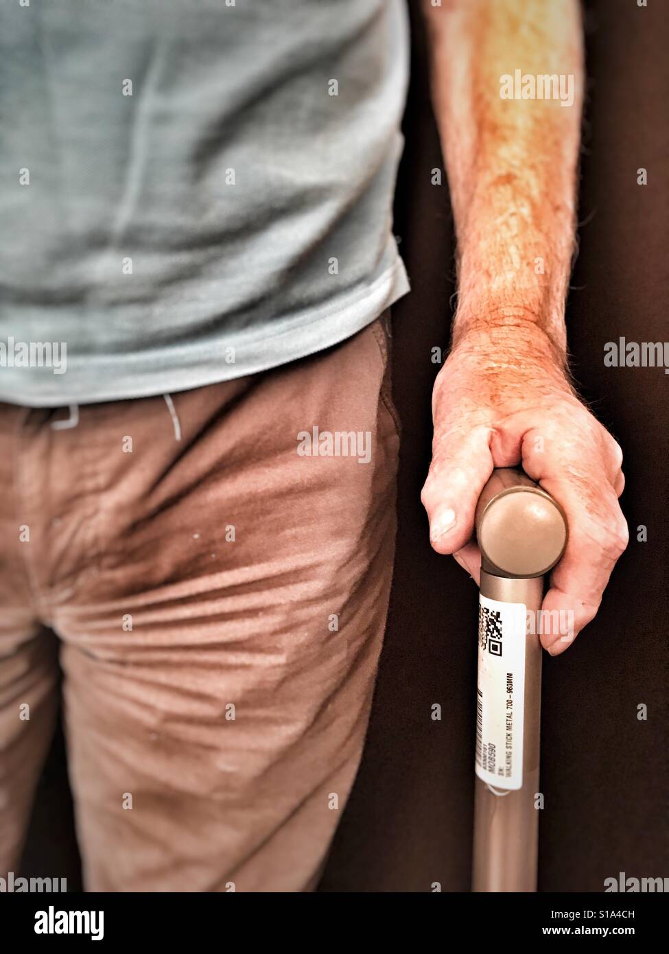 Elderly man with walking stick after replacement knee operation - Smartphone Captured Stock Image