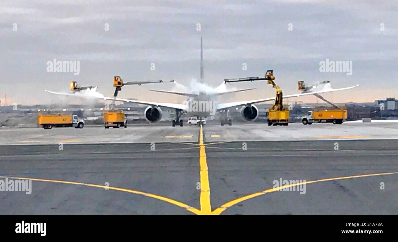Aircraft getting de-iced Stock Photo