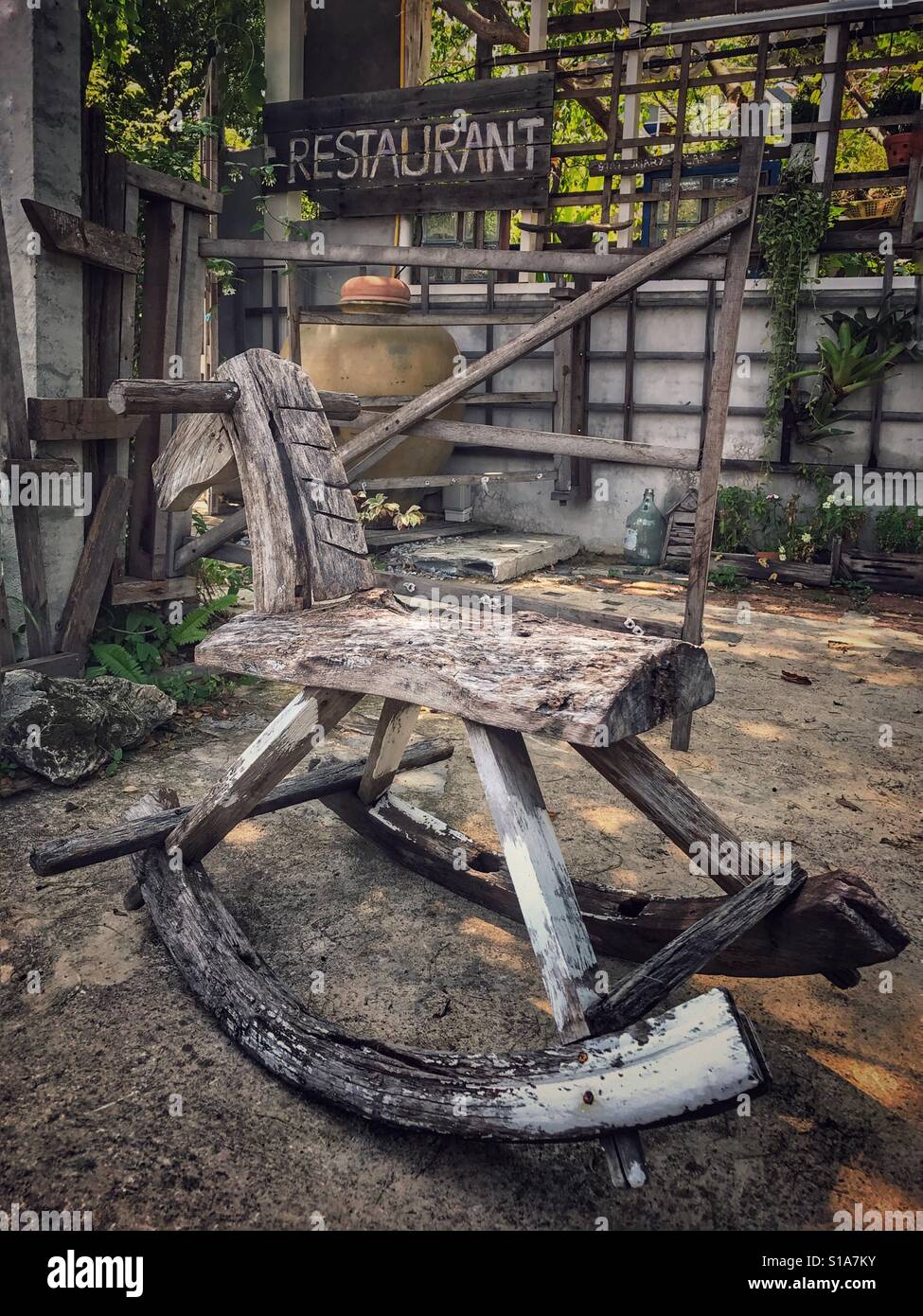 Wooden rocking horse in what was once the play area of an abandoned and derelict restaurant. Concept business failure - Smartphone Captured Stock Image