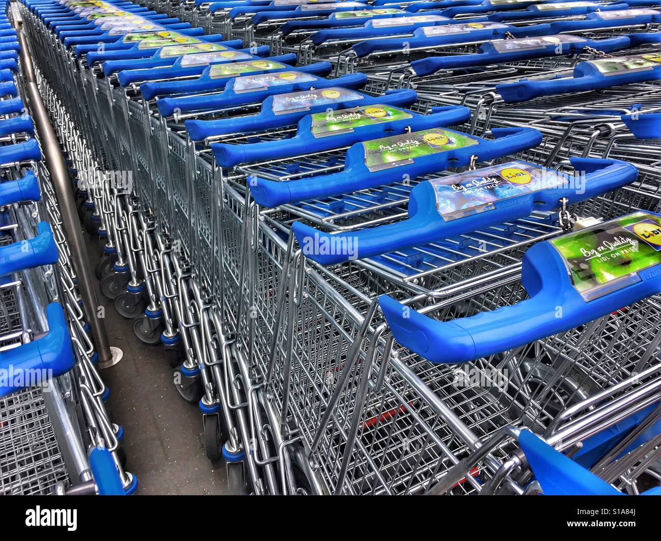 Nesting supermarket trolleys outside Lidl, - Smartphone Captured Stock Image
