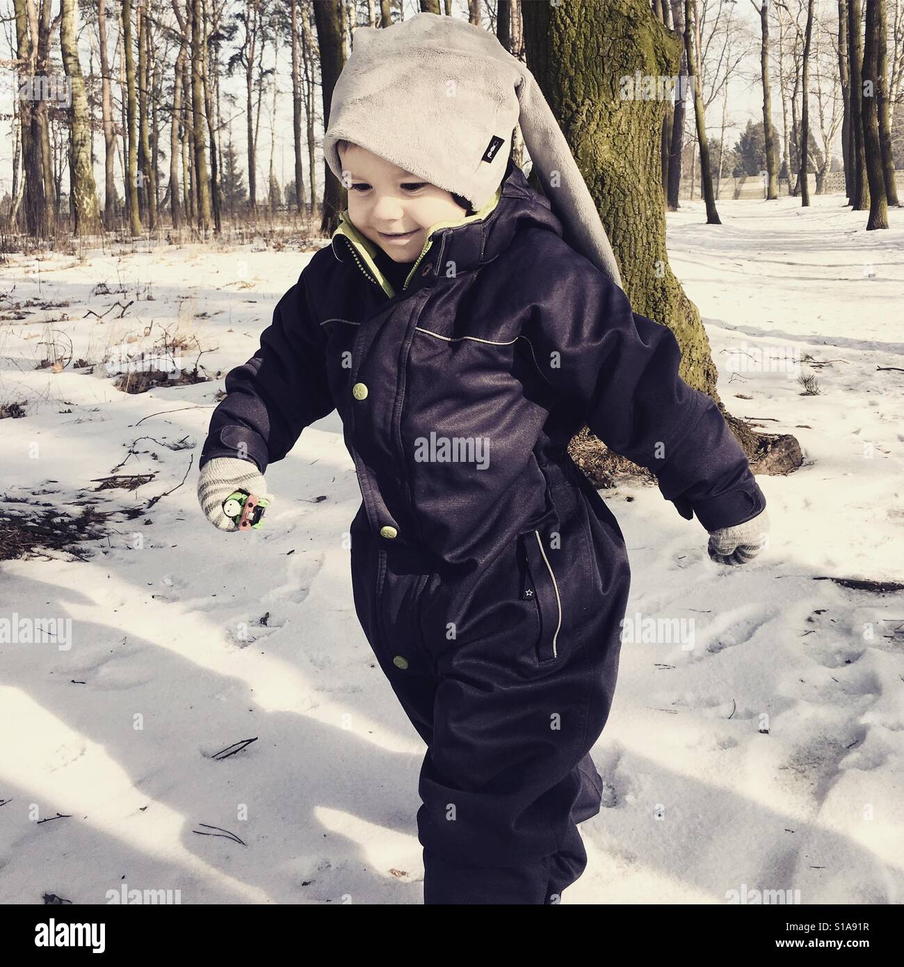 Toddler having fun in the snow Stock Photo