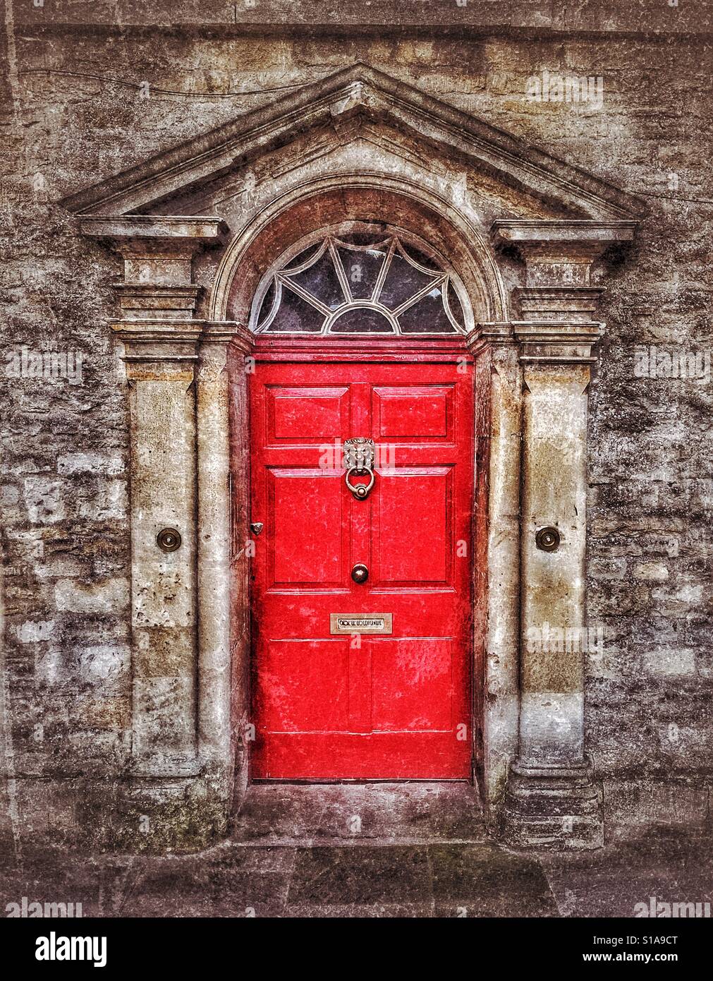 A bright red door provides the entrance to an elegant town house in a large town in England. Photo Credit - © COLIN HOSKINS. - Smartphone Captured Stock Image