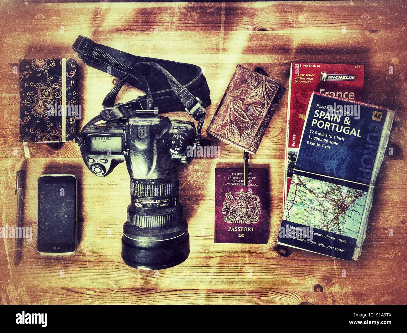 Travel items. Camera, cell phone, notebook, pen, passport, maps, wallet - Smartphone Captured Stock Image