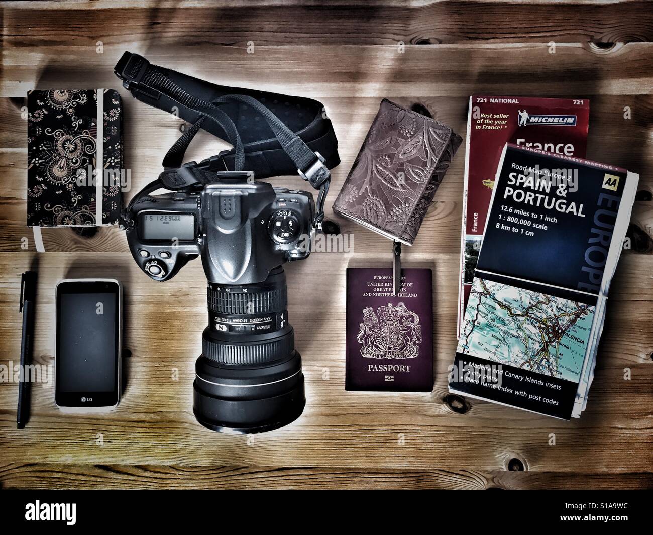 Travel items. DSLR camera, mobile phone / camera, passport, maps, notebook & pen, wallet. - Smartphone Captured Stock Image