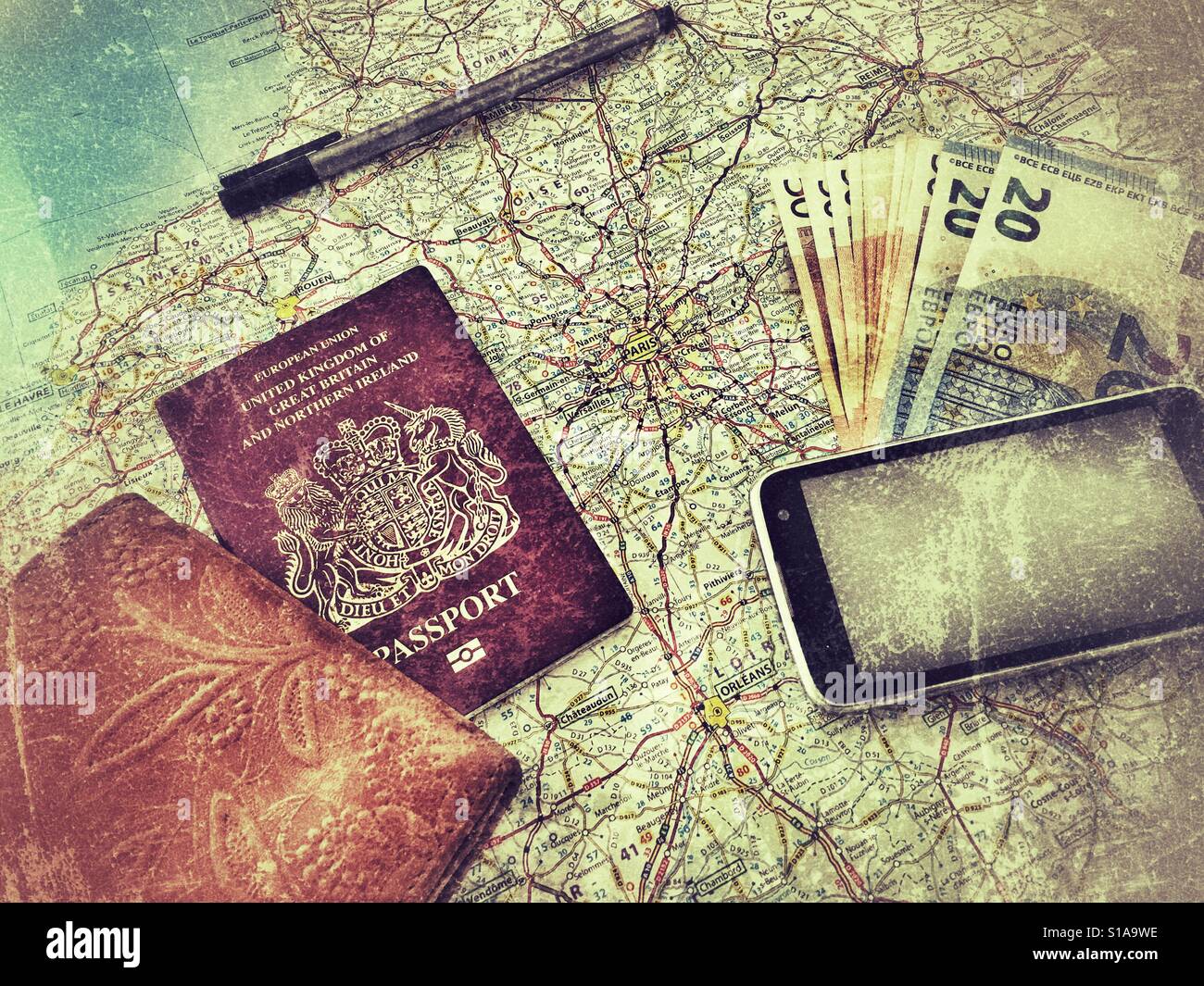 Getting ready to travel. Passport, money, map, wallet and phone / camera Stock Photo